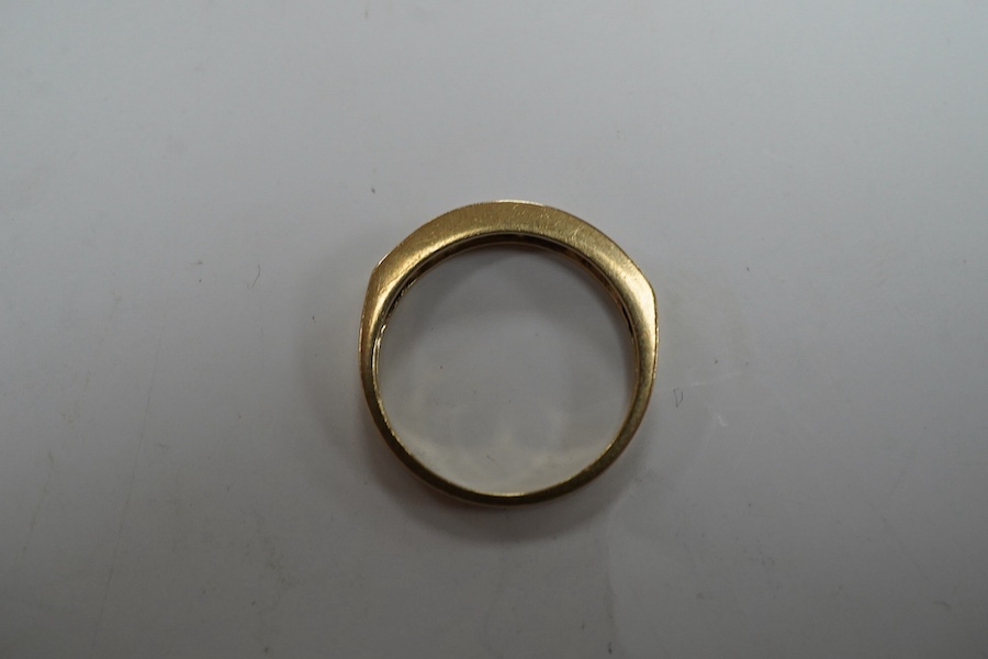 A modern 9ct gold and channel set sapphire and diamond set half hoop ring, size N/O, gross weight 2.2 grams. Condition - fair